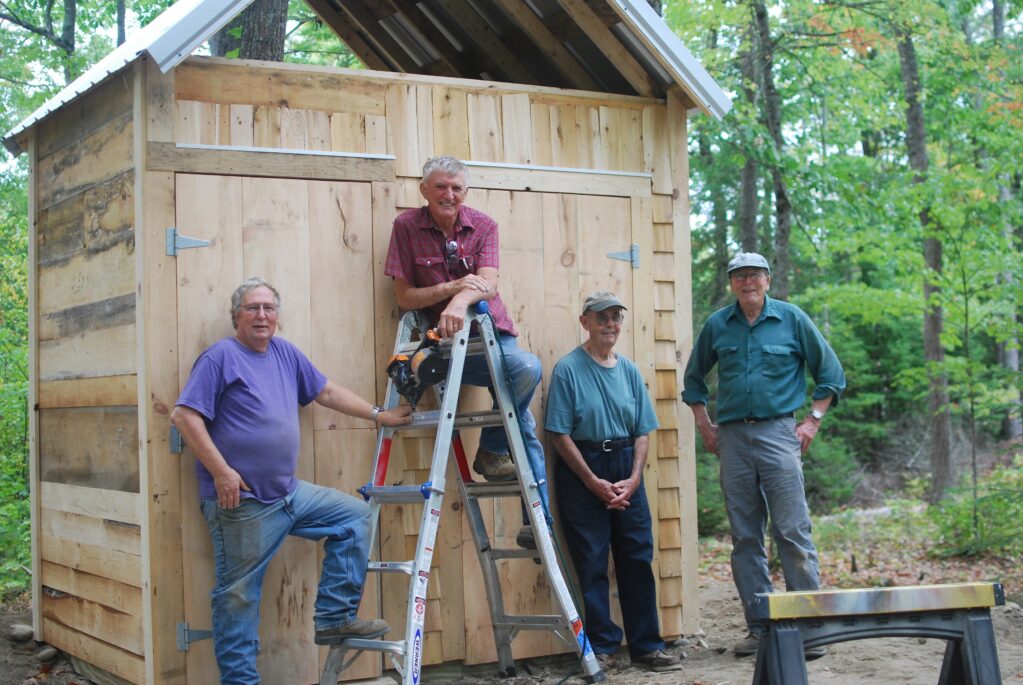 Tuesday Crew working on an outhouse.